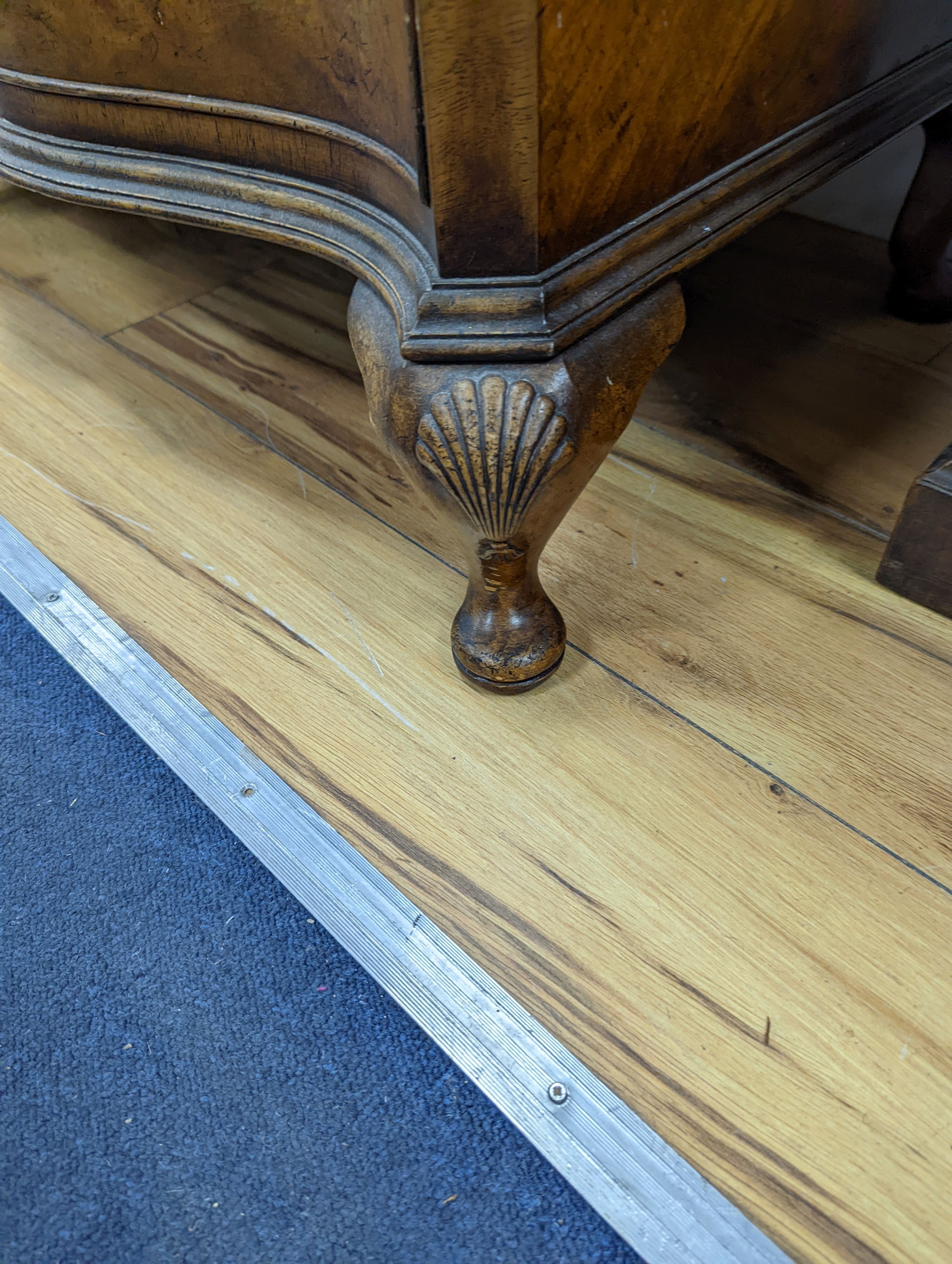 A 1920's Queen Anne revival banded walnut shaped front chest, width 76cm, depth 46cm, height 85cm